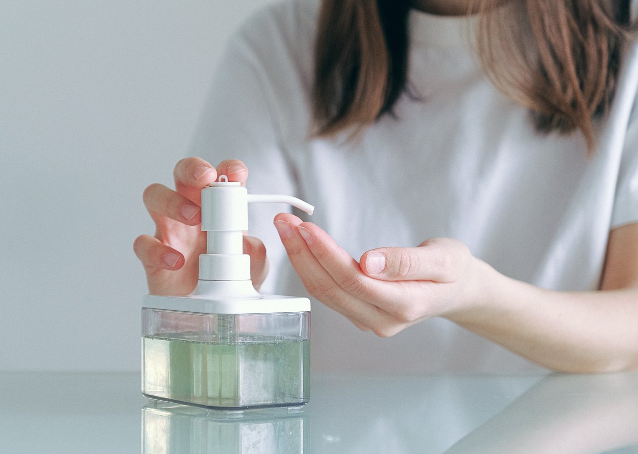 woman using hand sanitizer photo