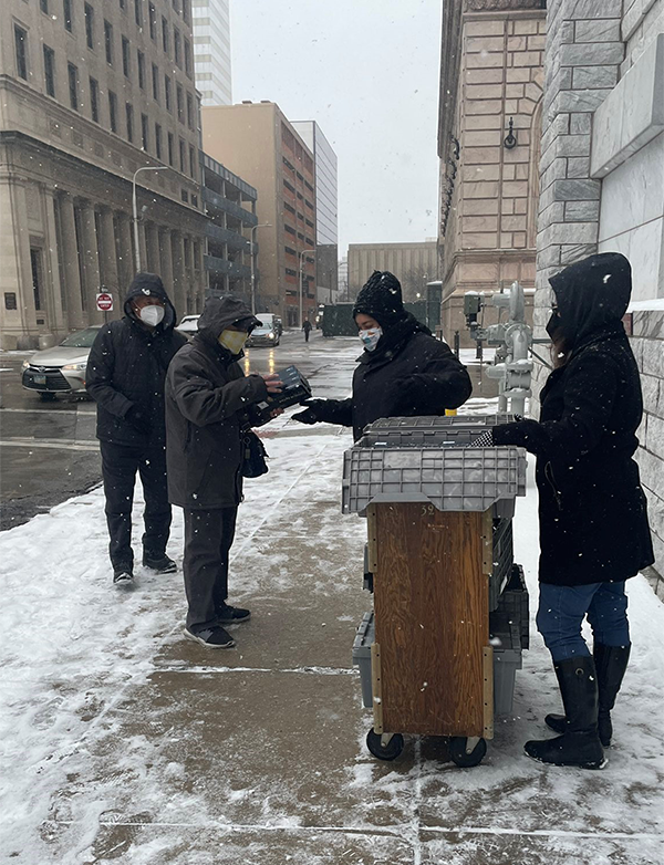 photo of staff passing out kits in snow