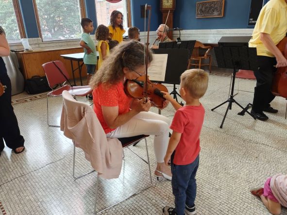 symphony storytime photo with musician and child