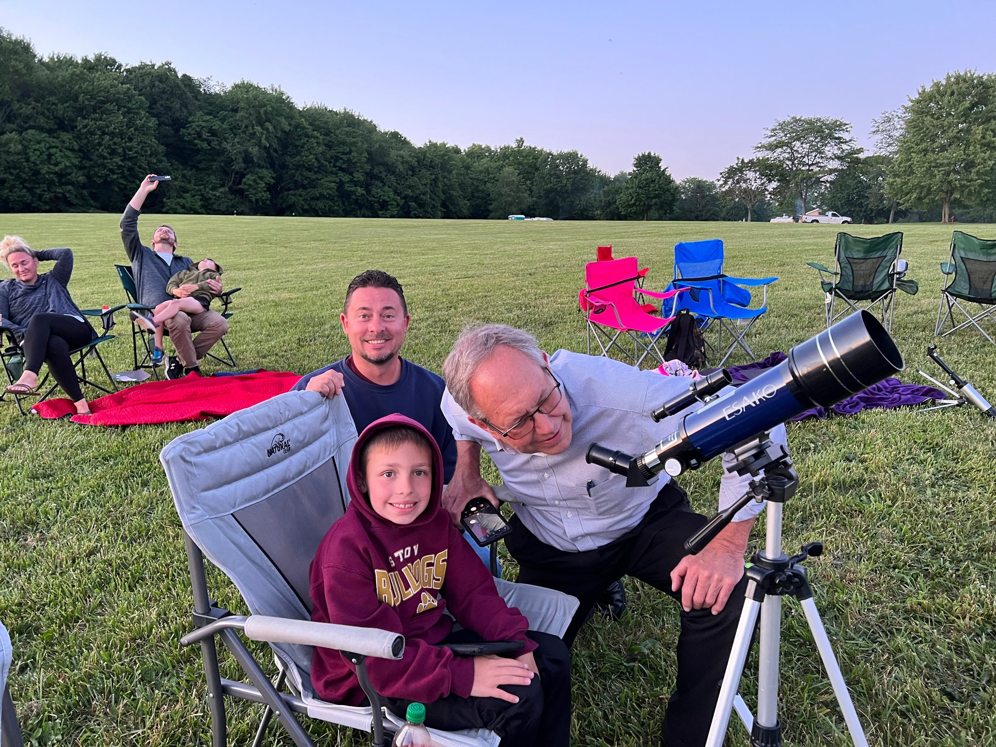 photo of family looking through telescope.