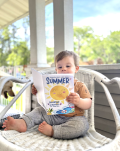 photo of baby reading magazine