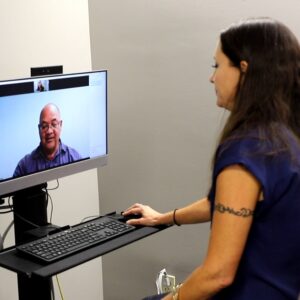 woman using computer for telehealth visit with doctor