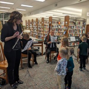 children looking at instruments at library