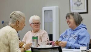 senior enjoying lunch together at the library