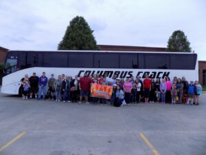 photo of families in front of coach bus