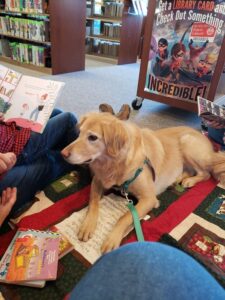 photo of dog listening to young reader